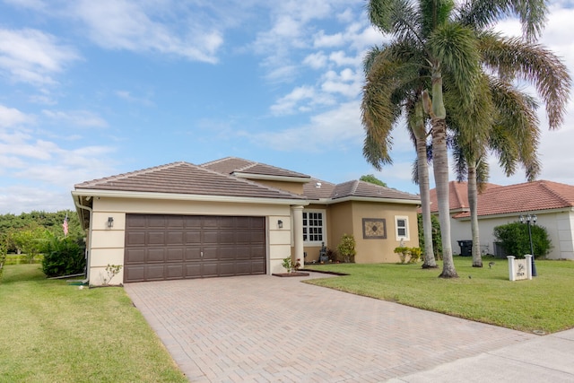 view of front of home with a garage and a front lawn