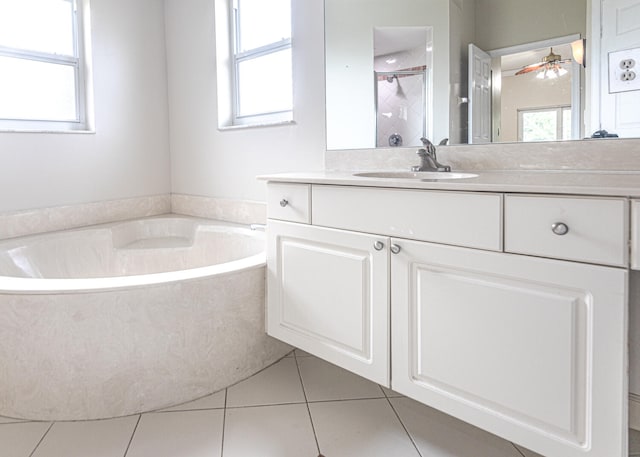 bathroom with tile patterned floors, separate shower and tub, and a healthy amount of sunlight