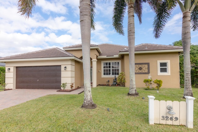 view of front facade with a garage and a front lawn