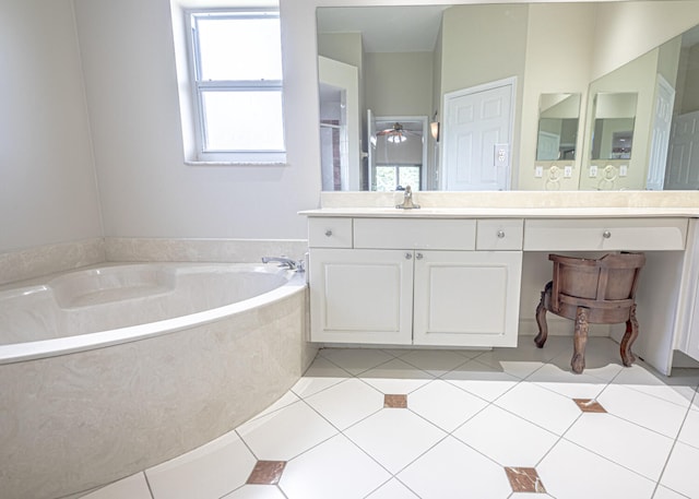 bathroom featuring a bathing tub, tile patterned flooring, and vanity