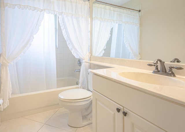 full bathroom with tile patterned flooring, vanity, shower / tub combo, and toilet