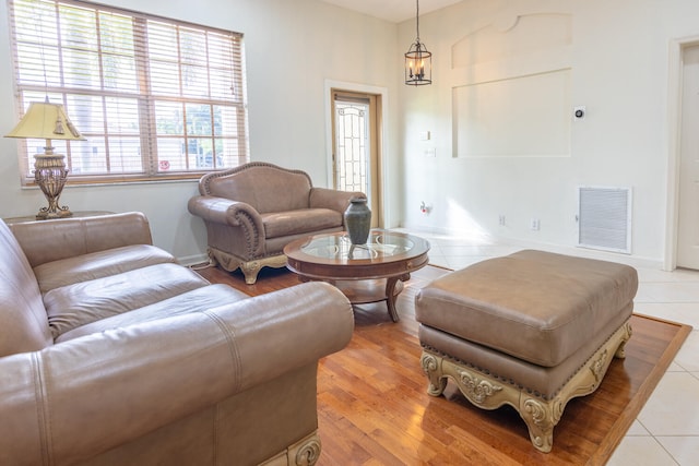 living room featuring light hardwood / wood-style floors and a notable chandelier