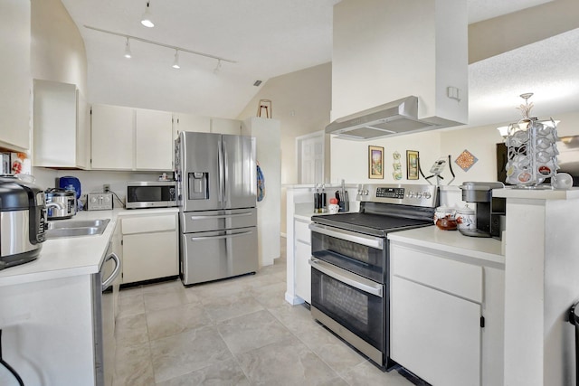 kitchen with white cabinets, vaulted ceiling, a textured ceiling, appliances with stainless steel finishes, and extractor fan