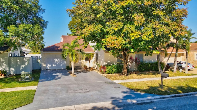 view of front of house with a front yard and a garage