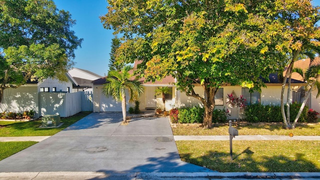 obstructed view of property featuring a front lawn