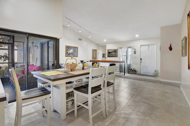 dining room featuring light tile patterned flooring and track lighting