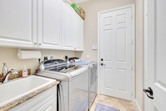 washroom featuring washer and clothes dryer, cabinets, and sink