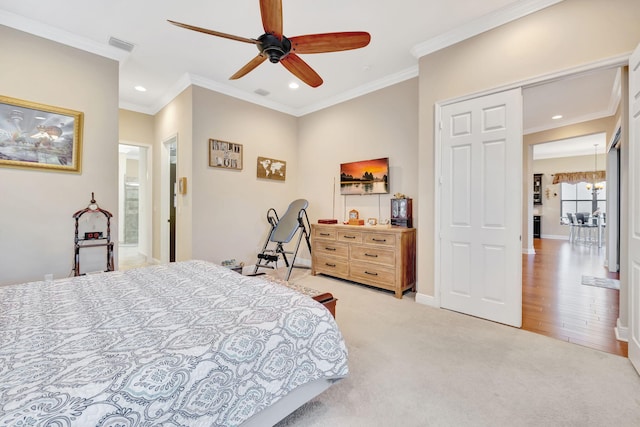 bedroom featuring ceiling fan, crown molding, and light carpet