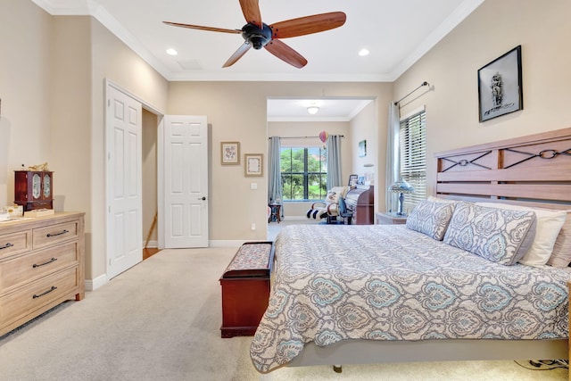 carpeted bedroom featuring ceiling fan and ornamental molding