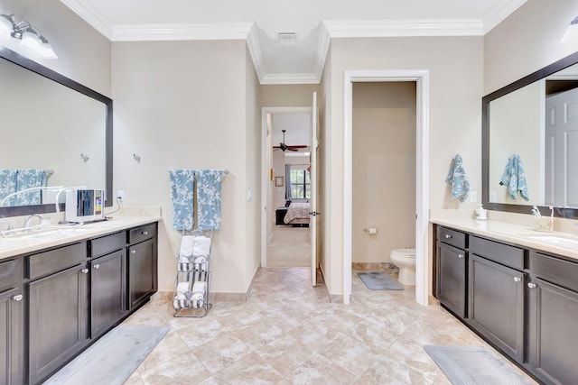 bathroom featuring ceiling fan, toilet, vanity, and ornamental molding