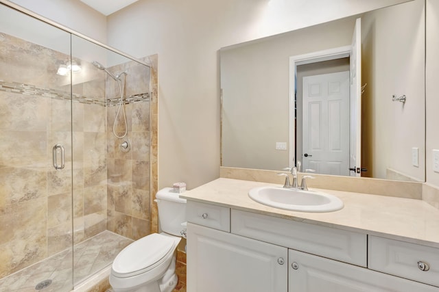 bathroom featuring vanity, toilet, and walk in shower