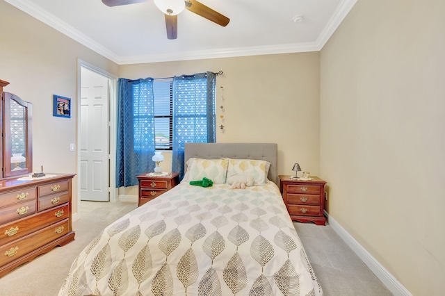 carpeted bedroom with ceiling fan and crown molding