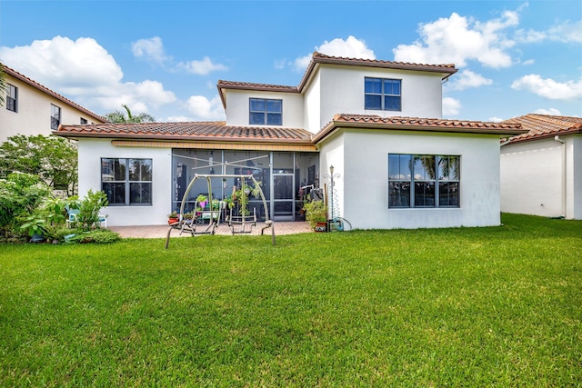 back of house with a lawn and a patio