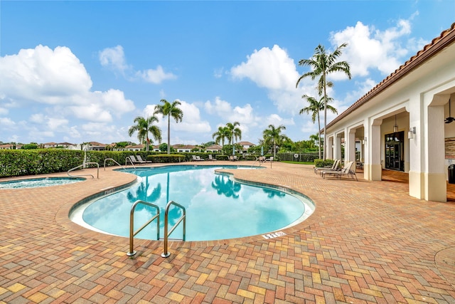 view of swimming pool with an in ground hot tub and a patio area