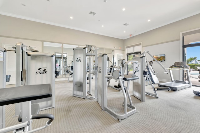 gym with crown molding and light carpet