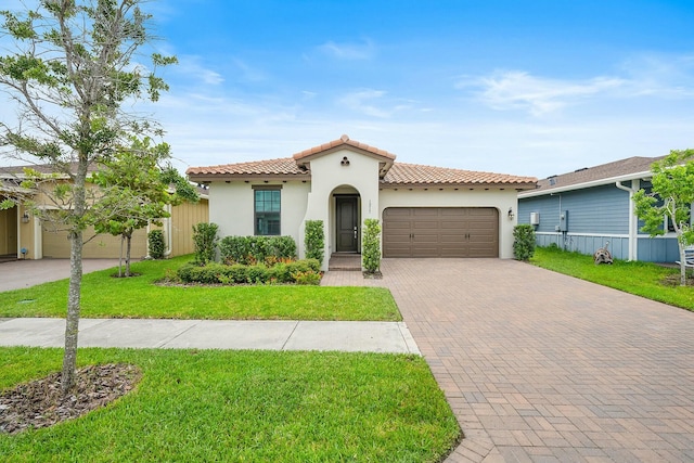 mediterranean / spanish house featuring a front yard and a garage