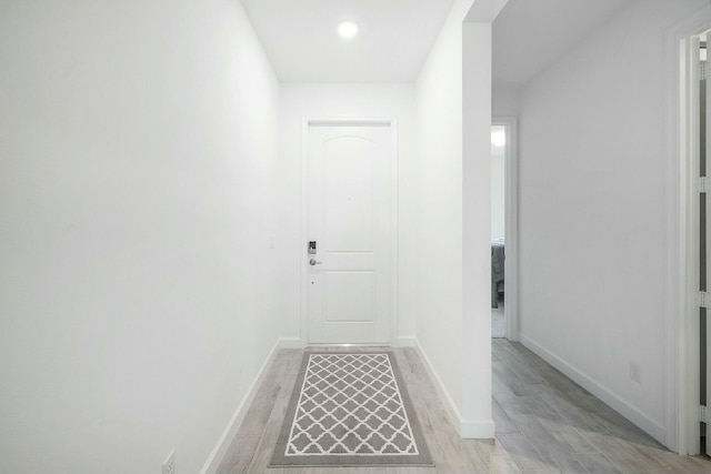 corridor with light hardwood / wood-style floors