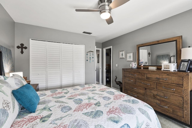 carpeted bedroom with a closet and ceiling fan