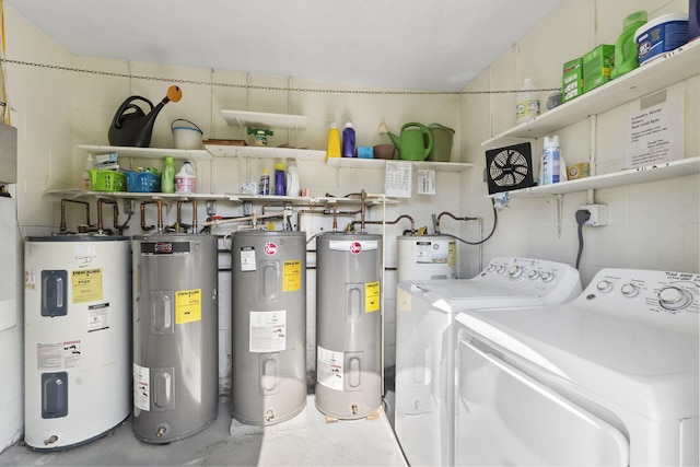 clothes washing area featuring washing machine and dryer and water heater