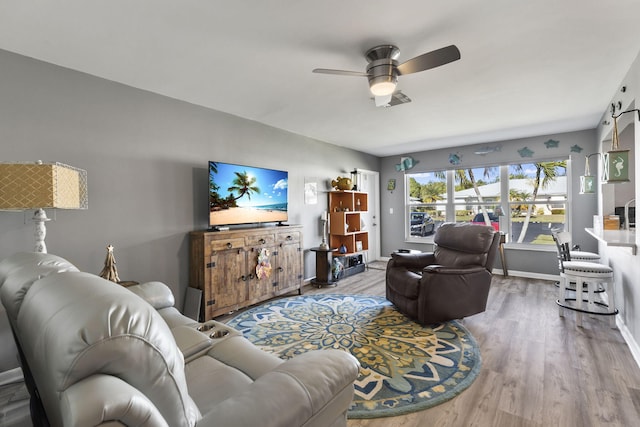 living room with ceiling fan and hardwood / wood-style flooring