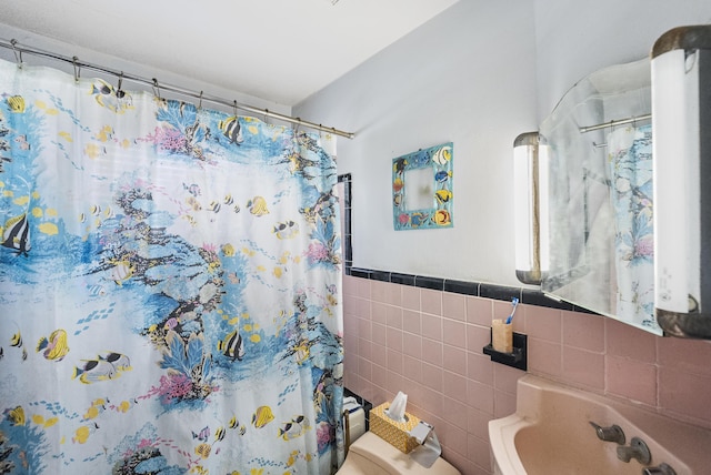 bathroom featuring tile walls and a shower with shower curtain