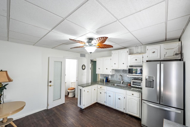 kitchen featuring white cabinets, sink, stainless steel appliances, and tasteful backsplash