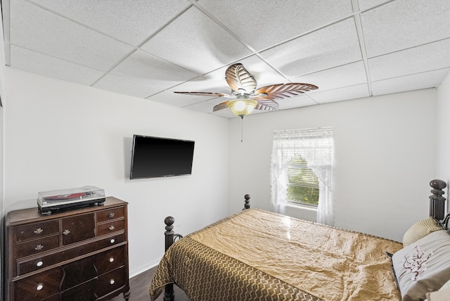 bedroom featuring a paneled ceiling, hardwood / wood-style flooring, and ceiling fan