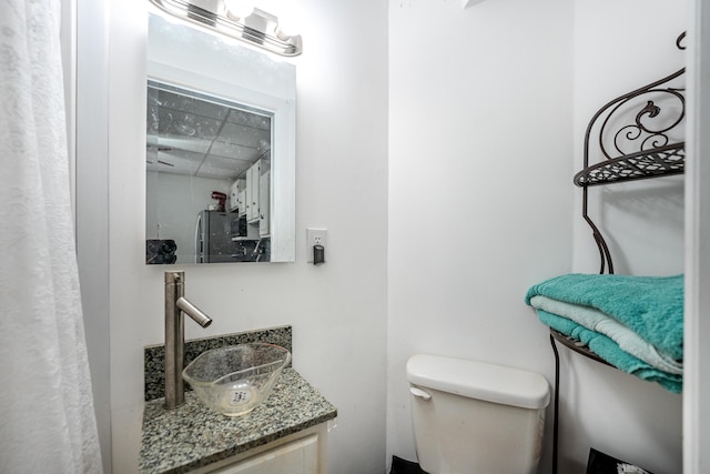 bathroom featuring vanity and toilet