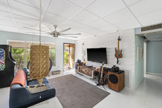 living room with a paneled ceiling and ceiling fan