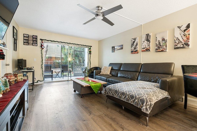 living room with ceiling fan, wood-type flooring, and a textured ceiling