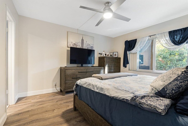 bedroom with hardwood / wood-style flooring and ceiling fan