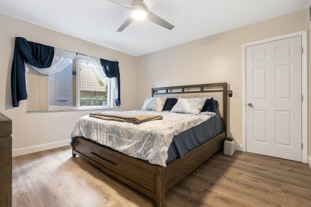 bedroom with ceiling fan and hardwood / wood-style flooring