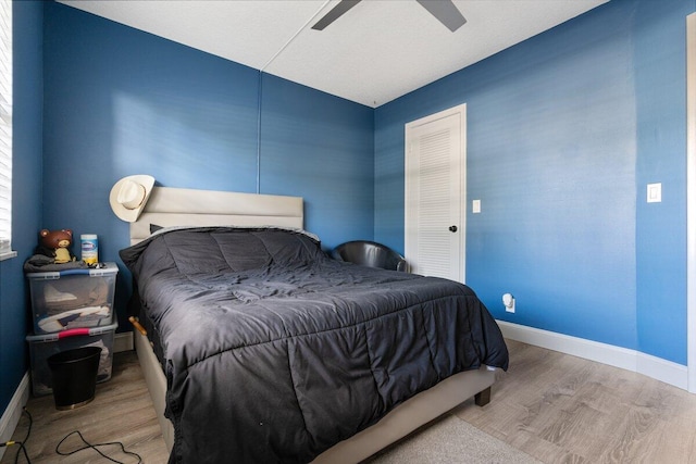 bedroom featuring light hardwood / wood-style floors and ceiling fan