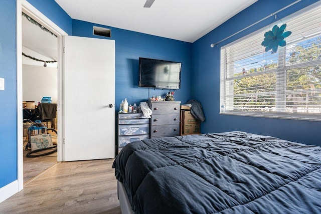 bedroom with ceiling fan, a closet, and hardwood / wood-style flooring