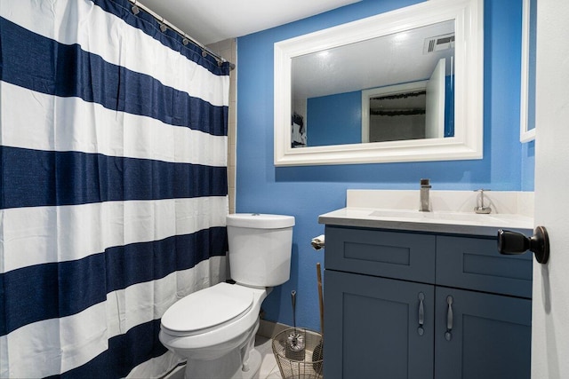 bathroom with vanity, curtained shower, and toilet