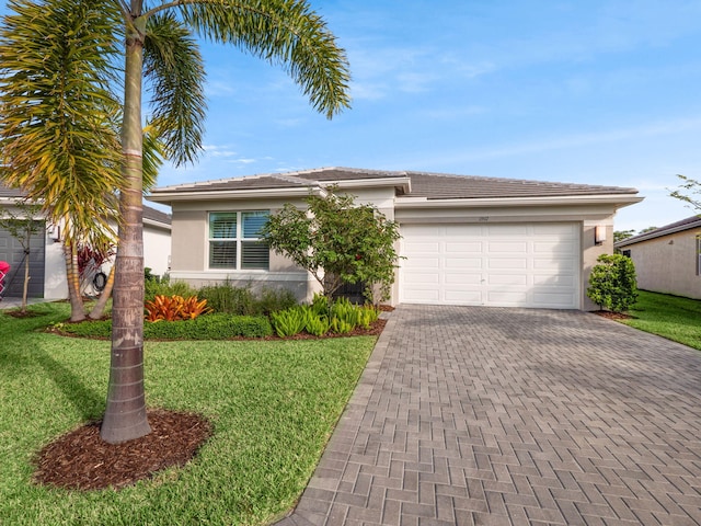 ranch-style home with a front yard and a garage