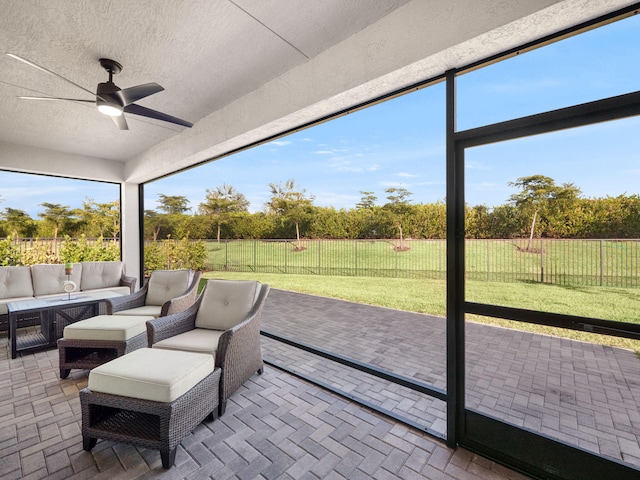 sunroom with ceiling fan and a wealth of natural light