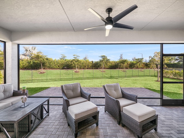 sunroom with ceiling fan and plenty of natural light