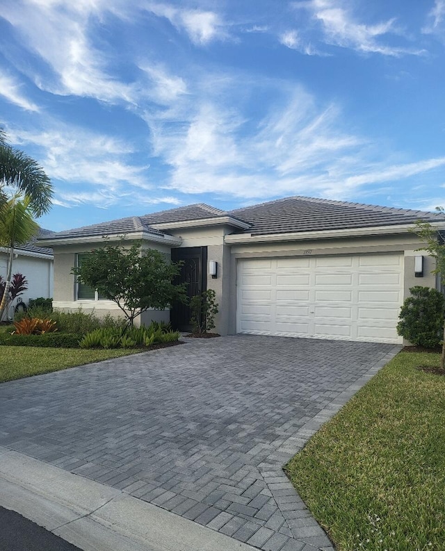 single story home with a front yard and a garage