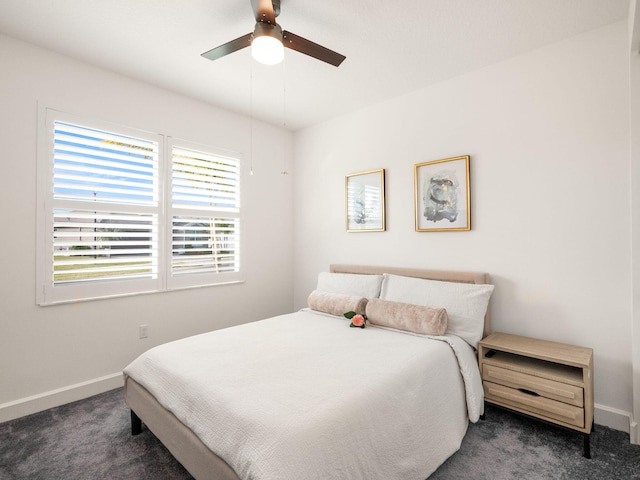 bedroom featuring dark colored carpet and ceiling fan