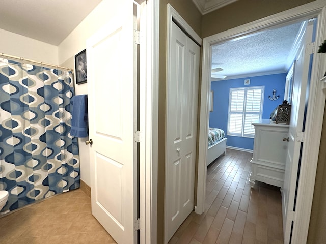 17976 88th Rd N, Loxahatchee, FL 33470 - ensuite bathroom featuring crown molding, toilet, baseboards, tile patterned floors, and curtained shower
