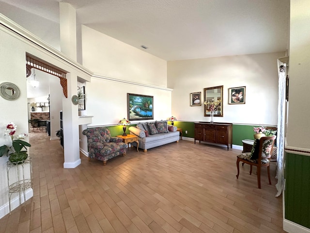 living room featuring hardwood / wood-style floors and high vaulted ceiling