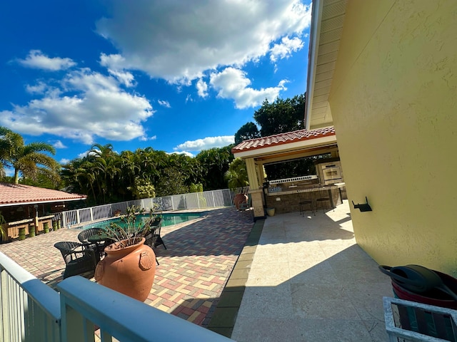 view of pool featuring an outdoor bar and a patio area