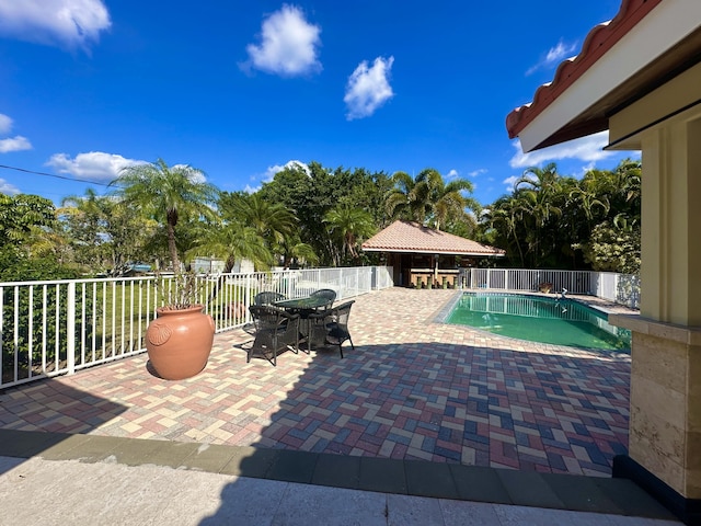 17976 88th Rd N, Loxahatchee, FL 33470 - view of swimming pool featuring a patio, a fenced backyard, and outdoor dining space