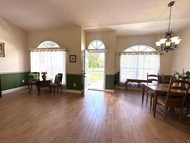 interior space with hardwood / wood-style floors, a chandelier, and a textured ceiling