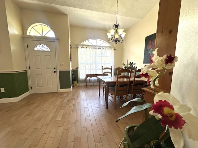 17976 88th Rd N, Loxahatchee, FL 33470 - entryway with a chandelier, healthy amount of natural light, wood finished floors, baseboards, and a textured ceiling