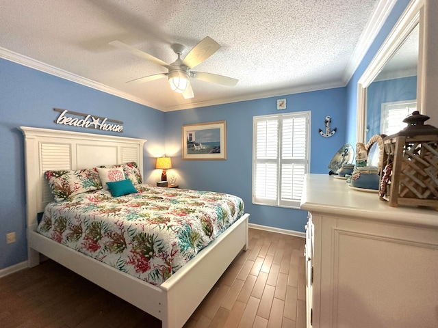 bedroom featuring multiple windows, wood-type flooring, ceiling fan, and crown molding