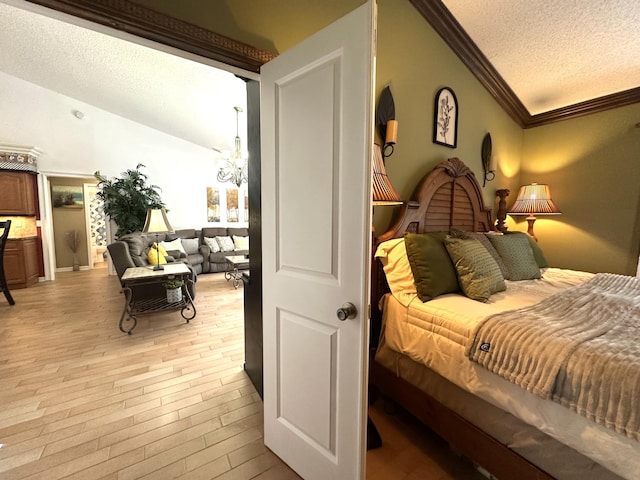 17976 88th Rd N, Loxahatchee, FL 33470 - bedroom with ornamental molding, a textured ceiling, a chandelier, and light wood-style floors
