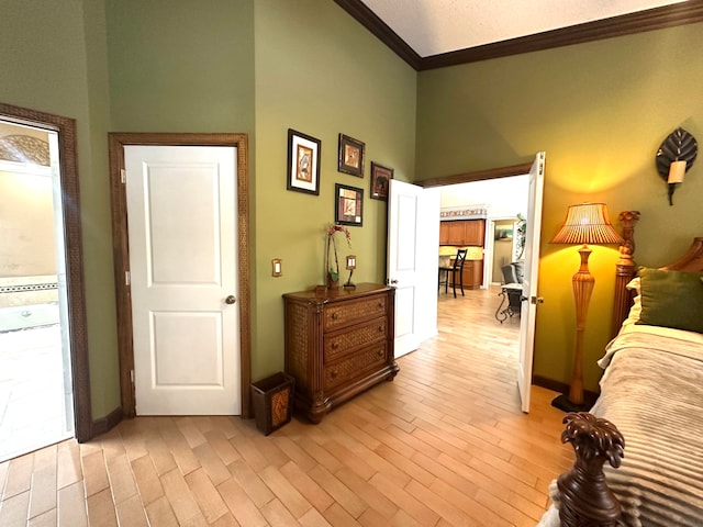 bedroom with light wood-type flooring and ornamental molding