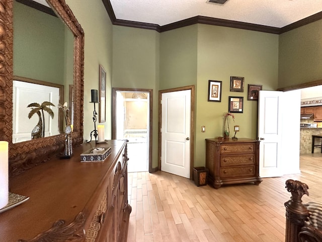 17976 88th Rd N, Loxahatchee, FL 33470 - bedroom featuring ornamental molding, light wood finished floors, a high ceiling, and a textured ceiling